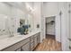 Modern bathroom featuring a double sink vanity, quartz countertops, and walk-in shower with sleek glass door at 487 Interlocken Blvd # 104, Broomfield, CO 80021