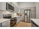 Modern kitchen with stainless steel appliances, gray cabinetry, and ample counter space at 487 Interlocken Blvd # 104, Broomfield, CO 80021