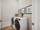 Convenient laundry room equipped with full-size washer and dryer and stylish decor at 487 Interlocken Blvd # 104, Broomfield, CO 80021
