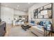 Comfortable living room featuring modern decor, a plush sofa, and an open layout to the kitchen at 487 Interlocken Blvd # 104, Broomfield, CO 80021
