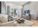 Relaxing living space with access to balcony, a stylish sofa, and contemporary entertainment center at 487 Interlocken Blvd # 104, Broomfield, CO 80021