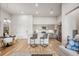 Bright living space with stainless steel appliances, gray cabinets, and a kitchen island with barstool seating at 487 Interlocken Blvd # 104, Broomfield, CO 80021