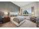 Serene main bedroom featuring a large window, textured accent wall and a comfortable seating area at 487 Interlocken Blvd # 104, Broomfield, CO 80021