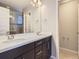 Bathroom with double sink vanity, modern fixtures, and tiled shower with glass door at 10071 Belvedere Cir, Lone Tree, CO 80124