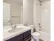 Bathroom featuring a shower-tub combo, single sink vanity and white fixtures at 10071 Belvedere Cir, Lone Tree, CO 80124