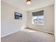 Neutral bedroom with a large window allowing natural light to illuminate the space at 10071 Belvedere Cir, Lone Tree, CO 80124