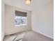 Bright bedroom featuring neutral walls, carpet, and a window with neighborhood views at 10071 Belvedere Cir, Lone Tree, CO 80124