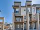 Contemporary townhome showcasing brick accents, balconies, and modern architectural details on a bright day at 10071 Belvedere Cir, Lone Tree, CO 80124