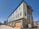 Exterior elevation of a multi-unit dwelling with garage doors, and modern design at 10071 Belvedere Cir, Lone Tree, CO 80124
