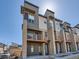 Modern townhome featuring private balconies, contemporary design, and inviting curb appeal on a sunny day at 10071 Belvedere Cir, Lone Tree, CO 80124