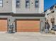 Exterior view of a unit's garage door with modern design and landscaping at 10071 Belvedere Cir, Lone Tree, CO 80124