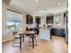 Modern kitchen open to dining area, featuring stainless steel appliances, dark cabinetry and lots of light at 10071 Belvedere Cir, Lone Tree, CO 80124