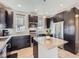 Well-appointed kitchen featuring granite countertops, stainless steel appliances, and dark cabinets for a modern feel at 10071 Belvedere Cir, Lone Tree, CO 80124