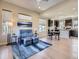 Open-concept living space featuring the kitchen and a comfortable sitting area with a blue loveseat at 10071 Belvedere Cir, Lone Tree, CO 80124