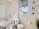Bright powder room featuring a pedestal sink and modern decor at 10071 Belvedere Cir, Lone Tree, CO 80124