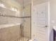 Glass enclosed shower with tiled walls, mosaic accents, and rainfall showerhead at 10071 Belvedere Cir, Lone Tree, CO 80124