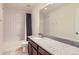 A full bathroom offers a shower with a white-tiled surround and a dark blue shower curtain at 133 Poppy View Ln, Erie, CO 80516