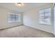 Cozy bedroom with neutral carpeting and two windows, offering ample natural light and a comfortable space at 133 Poppy View Ln, Erie, CO 80516