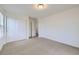 Light-filled bedroom with neutral carpeting and a closet, providing a serene and functional living space at 133 Poppy View Ln, Erie, CO 80516