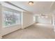 Large open bedroom with big windows, neutral paint, and ceiling fan at 133 Poppy View Ln, Erie, CO 80516