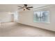 Generous bonus room featuring a ceiling fan, ample natural light, and neutral carpeting at 133 Poppy View Ln, Erie, CO 80516
