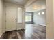 Bright foyer featuring a window and hardwood floors with an open concept to the living room at 133 Poppy View Ln, Erie, CO 80516