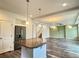 Bright open space featuring kitchen island, pendant lights and stainless steel fridge at 133 Poppy View Ln, Erie, CO 80516