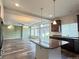 Modern kitchen island with granite countertop, hardwood floors and stainless steel appliances at 133 Poppy View Ln, Erie, CO 80516