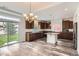 Bright kitchen with granite countertops, dark wood cabinetry, and stainless steel appliances, offering style and function at 133 Poppy View Ln, Erie, CO 80516