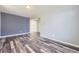 Minimalist-inspired living room with gray walls and hardwood floors, creating a bright and airy atmosphere at 133 Poppy View Ln, Erie, CO 80516