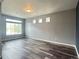 Open-concept living room featuring lots of natural light and hardwood floors at 133 Poppy View Ln, Erie, CO 80516
