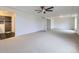 Large main bedroom with a ceiling fan, neutral carpeting, and an ensuite bathroom and walk-in closet at 133 Poppy View Ln, Erie, CO 80516