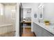 Contemporary bathroom featuring a glass-enclosed shower and dual sink vanity at 785 Dexter St, Denver, CO 80220