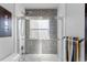 Bright bathroom featuring a shower with blue mosaic tiles and a glass door at 785 Dexter St, Denver, CO 80220