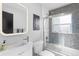 Bright bathroom featuring a modern vanity, toilet, and shower with blue mosaic tile accents at 785 Dexter St, Denver, CO 80220