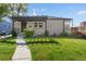 Inviting home exterior with a stylish pergola, lush lawn, and an attractive walkway at 785 Dexter St, Denver, CO 80220