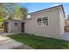 Exterior side view of the grey, detached two-car garage with a small lawn at 785 Dexter St, Denver, CO 80220