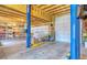 Spacious garage with high ceilings, two garage doors, a car lift, and ample storage space at 785 Dexter St, Denver, CO 80220