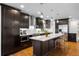 Beautiful kitchen with dark wood cabinets, stainless steel appliances, and a spacious island at 785 Dexter St, Denver, CO 80220