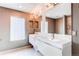 Bright bathroom featuring double sinks, modern lighting, and an accent mirror at 3607 Dinosaur St, Castle Rock, CO 80109