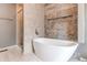 Modern bathroom featuring a soaking tub, tiled accent wall, and glass-enclosed shower at 3607 Dinosaur St, Castle Rock, CO 80109