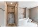 Elegant bathroom showcasing a stylish shower with pebble floor, soaking tub, and modern toilet at 3607 Dinosaur St, Castle Rock, CO 80109