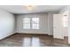 Bright bedroom with hardwood floors, windows, and a door at 3607 Dinosaur St, Castle Rock, CO 80109