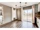 A dining area with modern lighting fixture, sliding glass door to the backyard and wood floors at 3607 Dinosaur St, Castle Rock, CO 80109