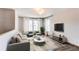 Airy living room with modern furnishings, large windows, and a neutral color palette at 3607 Dinosaur St, Castle Rock, CO 80109