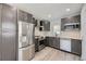 Modern kitchen with stainless steel appliances, ample counter space, and gray cabinetry at 1270 S Tennyson St, Denver, CO 80219