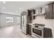 Gorgeous kitchen featuring stainless steel appliances and open access to the living room at 1270 S Tennyson St, Denver, CO 80219