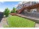 The backyard has a hammock, stone and turf landscaping, and a second-story deck with stairs at 7410 S Old Hammer Way, Aurora, CO 80016