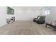 Basement with a large sitting area, media console, and windows offering natural light at 7410 S Old Hammer Way, Aurora, CO 80016