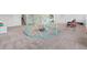 Spacious basement featuring an indoor play area with a dome climber and soft carpet flooring at 7410 S Old Hammer Way, Aurora, CO 80016